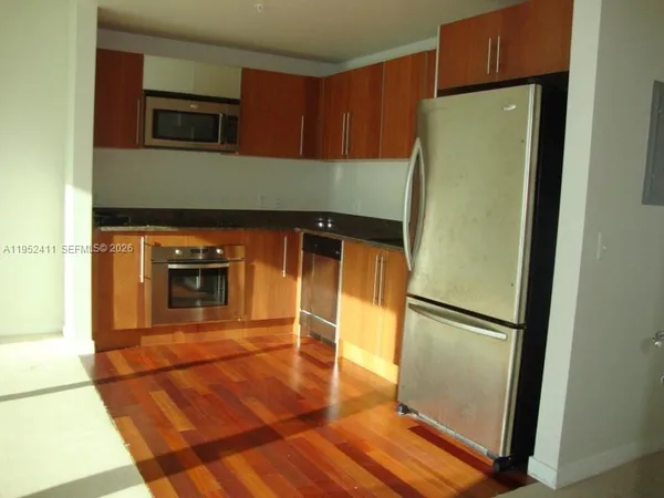 a kitchen with a refrigerator and a microwave