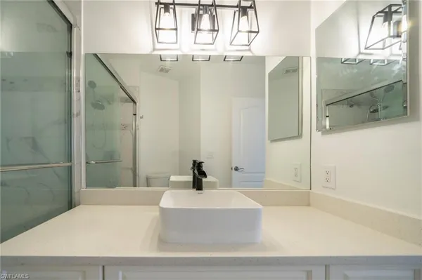 a bathroom with a tub shower and sink