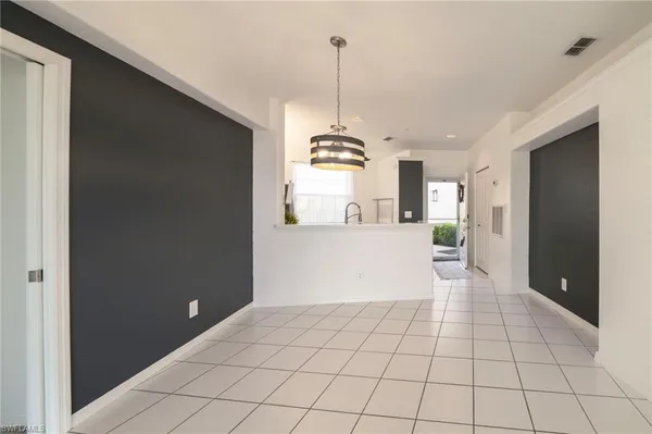 a view of a kitchen with furniture and an empty room
