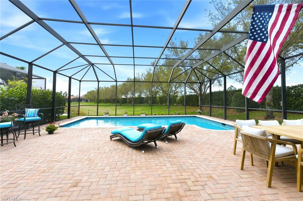 3306 Baltic Drive Naples, FL 34119 - Photo 1 of 49 a view of swimming pool with lawn chairs and a yard