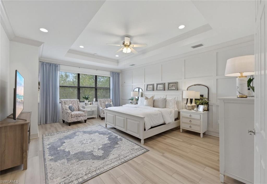 3306 Baltic Drive Naples, FL 34119 - Photo 18 of 49 a spacious bedroom with a bed and a large window