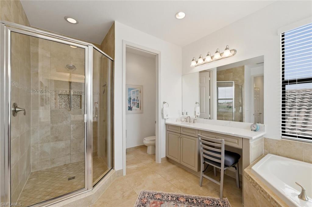 3306 Baltic Drive Naples, FL 34119 - Photo 21 of 49 a spacious bathroom with a shower sink and mirror
