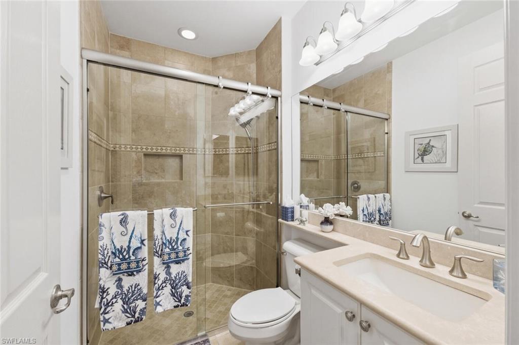 3306 Baltic Drive Naples, FL 34119 - Photo 23 of 49 a bathroom with a sink vanity granite toilet and shower
