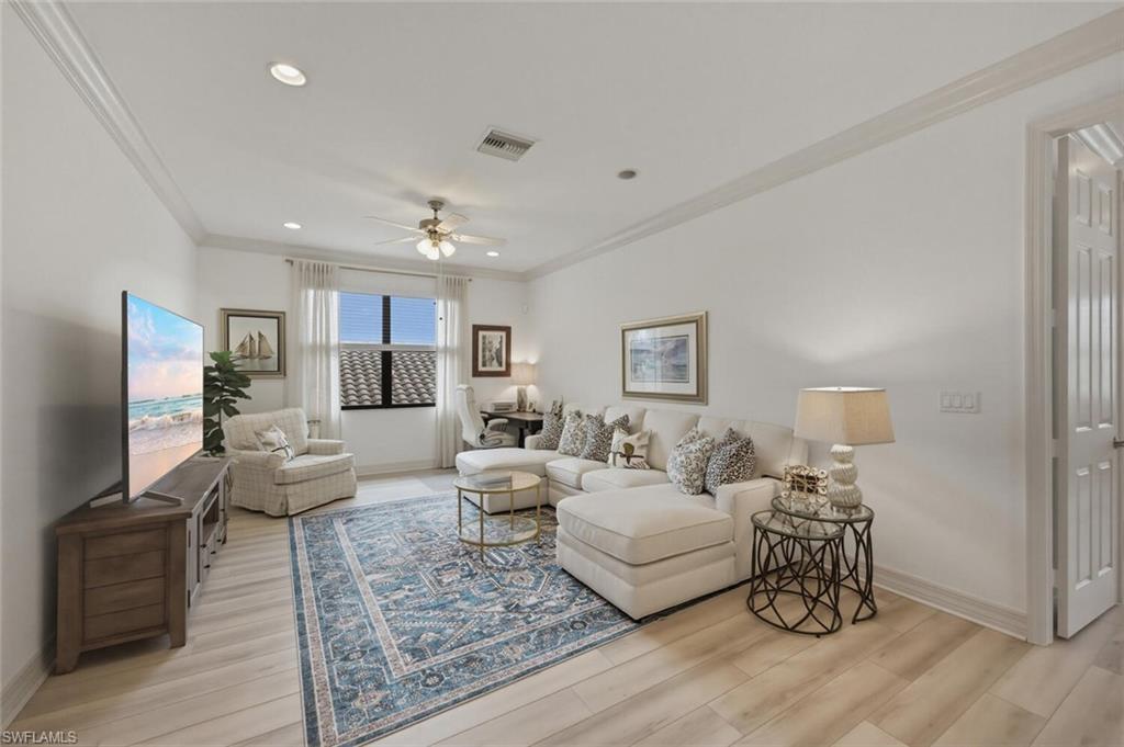 3306 Baltic Drive Naples, FL 34119 - Photo 25 of 49 a living room with furniture and a wooden floor