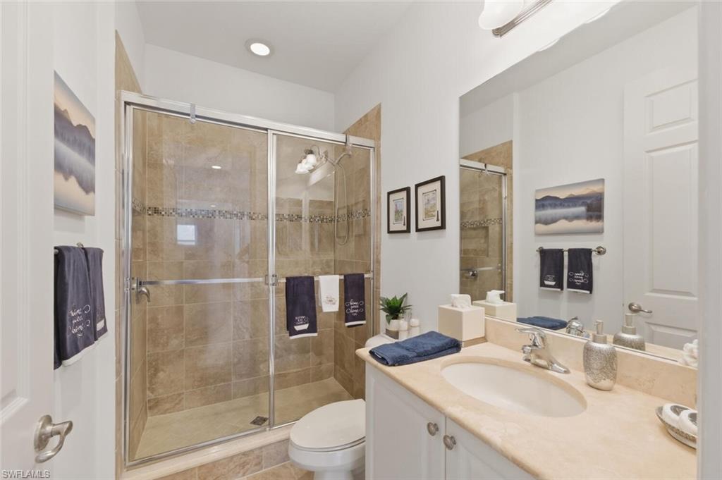 3306 Baltic Drive Naples, FL 34119 - Photo 32 of 49 a bathroom with a sink toilet and shower