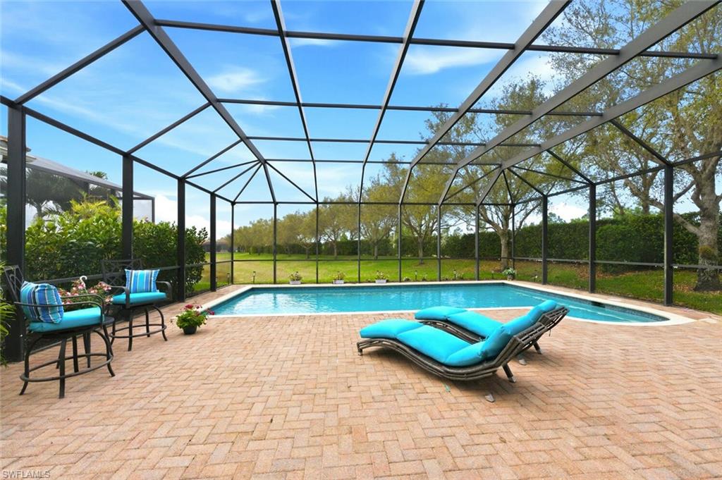 3306 Baltic Drive Naples, FL 34119 - Photo 34 of 49 a view of swimming pool with lounge chairs in patio