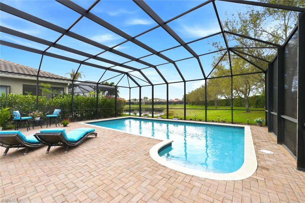 3306 Baltic Drive Naples, FL 34119 - Photo 35 of 49 a view of a swimming pool with a patio