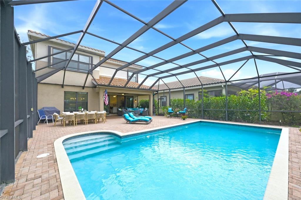 3306 Baltic Drive Naples, FL 34119 - Photo 36 of 49 a view of a swimming pool with a patio