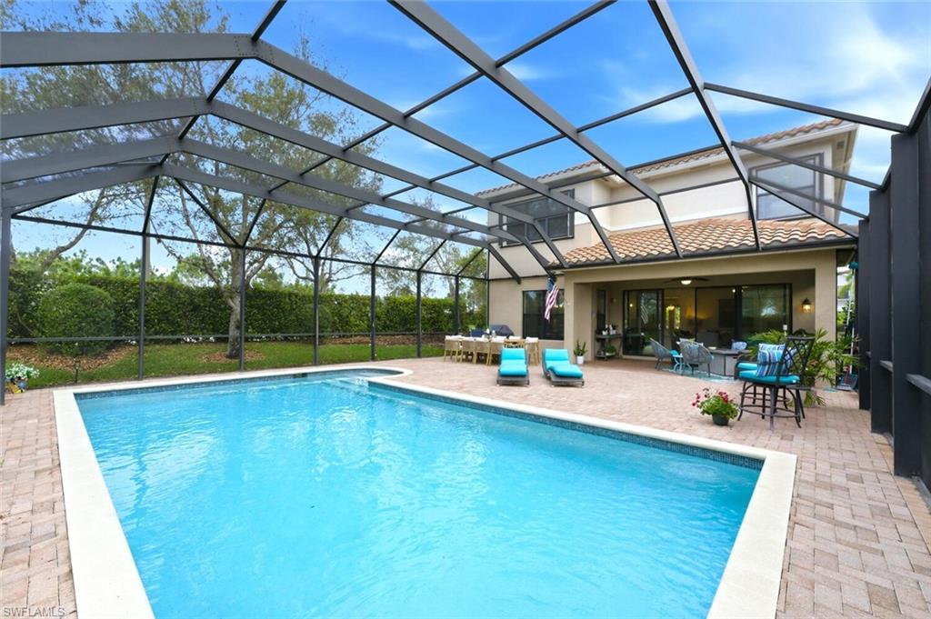 3306 Baltic Drive Naples, FL 34119 - Photo 37 of 49 a view of a swimming pool with a patio