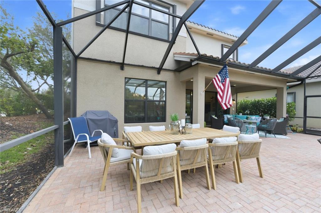3306 Baltic Drive Naples, FL 34119 - Photo 39 of 49 a view of a dining table and chairs in the patio
