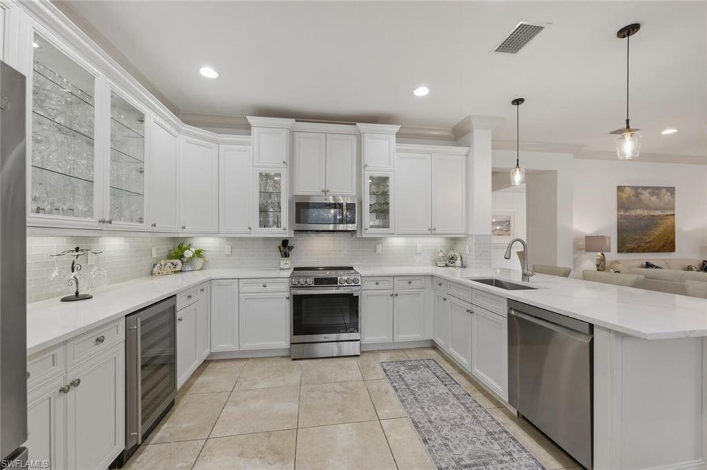 3306 Baltic Drive Naples, FL 34119 - Photo 4 of 49 a kitchen with a sink stove top oven and cabinets