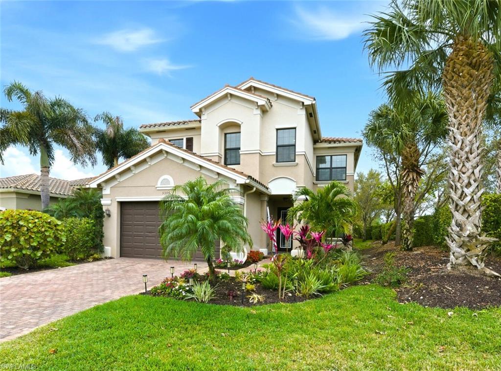 3306 Baltic Drive Naples, FL 34119 - Photo 42 of 49 a front view of a house with a yard and potted plants