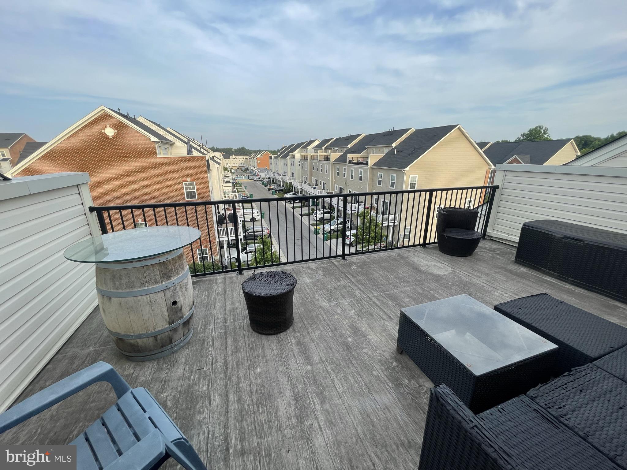 7563 Crowley Street Hanover, MD 21076 - Photo 13 of 15 a view of a roof deck with chair and wooden floor