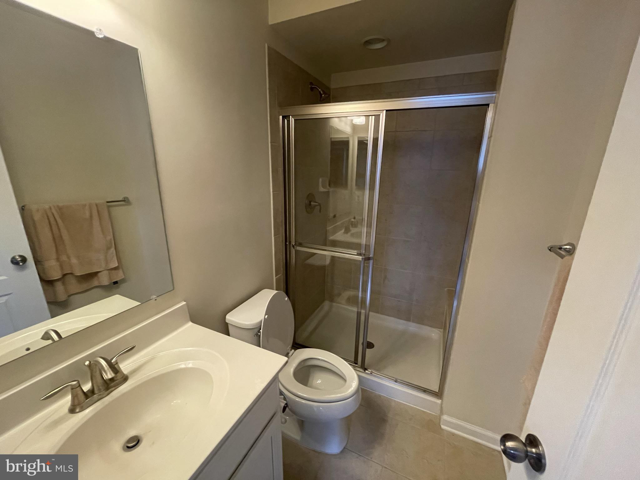7563 Crowley Street Hanover, MD 21076 - Photo 3 of 15 a bathroom with a sink toilet and shower