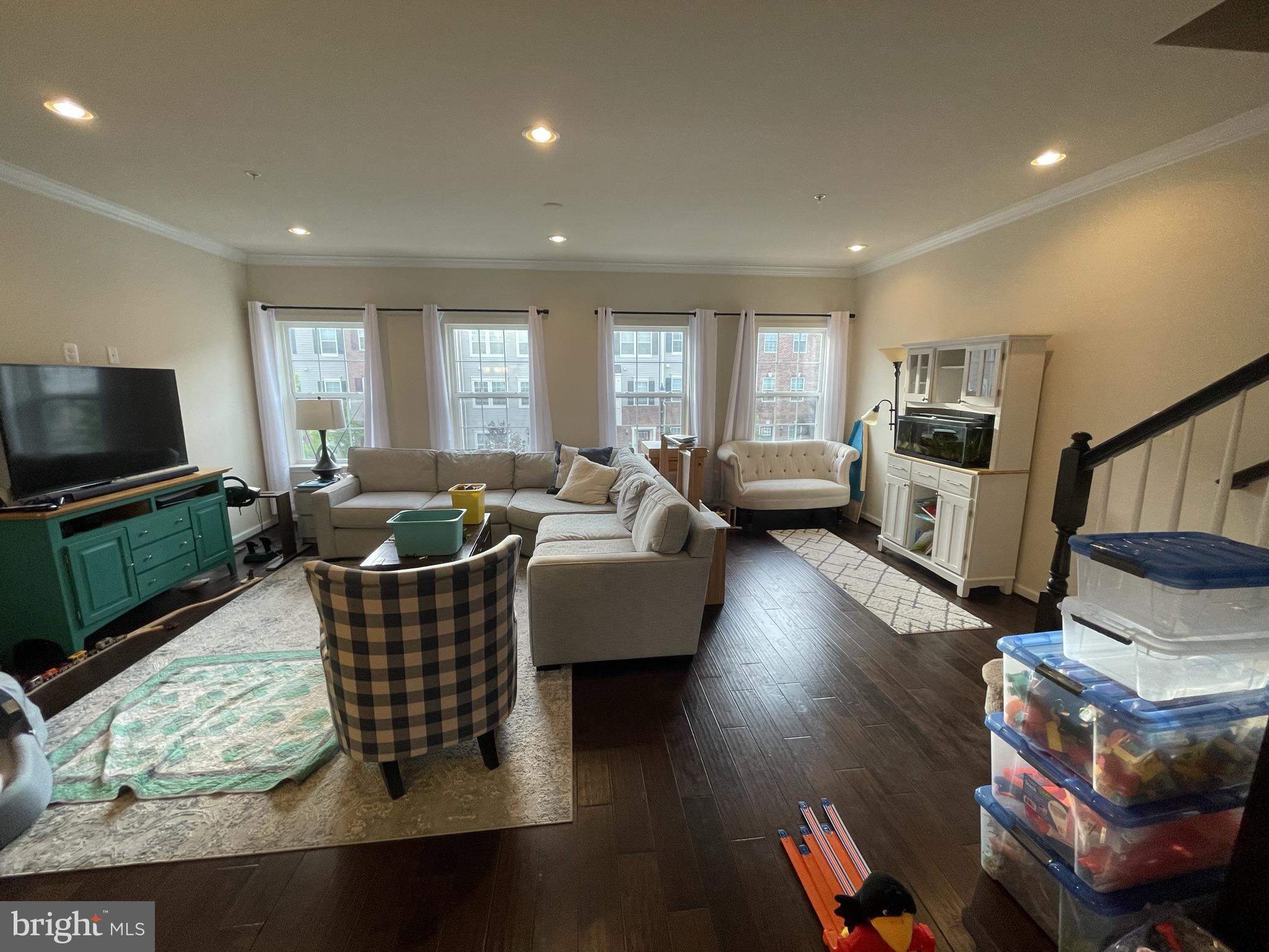 7563 Crowley Street Hanover, MD 21076 - Photo 5 of 15 a living room with fireplace furniture and a flat screen tv
