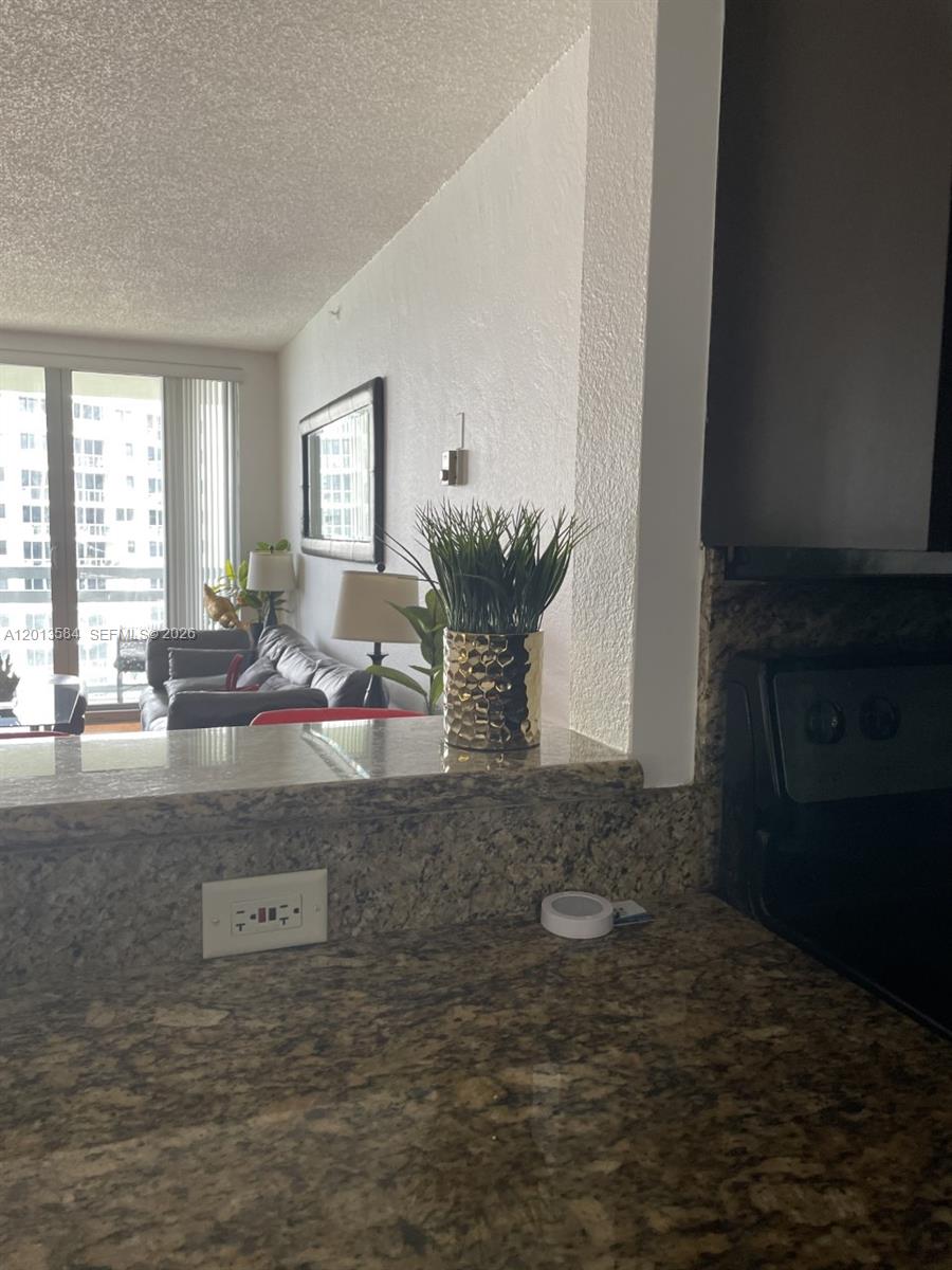 1500 Bay Road, Unit 1142S Miami Beach, FL 33139 - Photo 3 of 8 a view of a kitchen with granite countertop