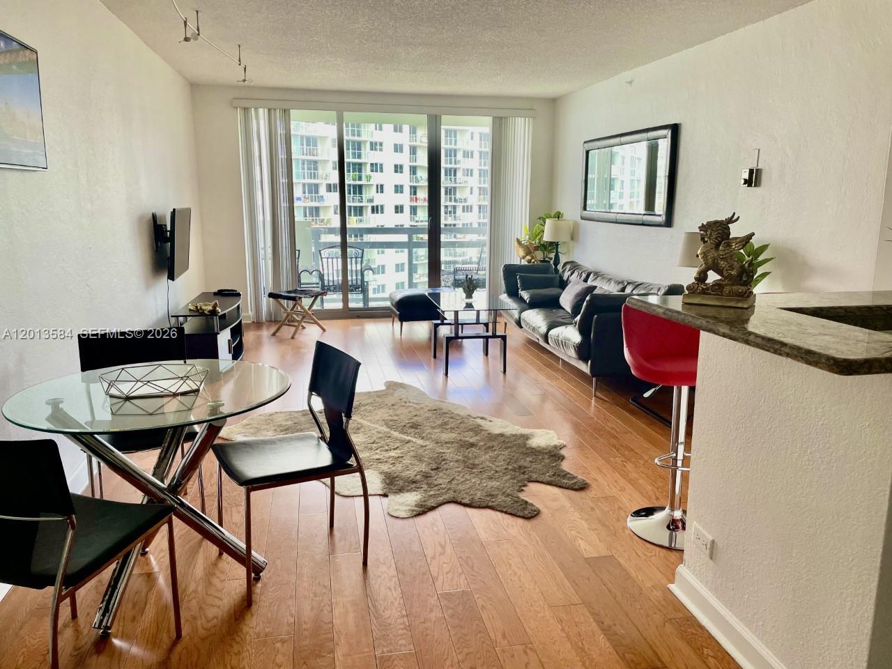 1500 Bay Road, Unit 1142S Miami Beach, FL 33139 - Photo 8 of 8 a living room with furniture and floor to ceiling windows