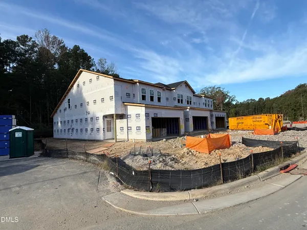 a view of a house with pool and chairs