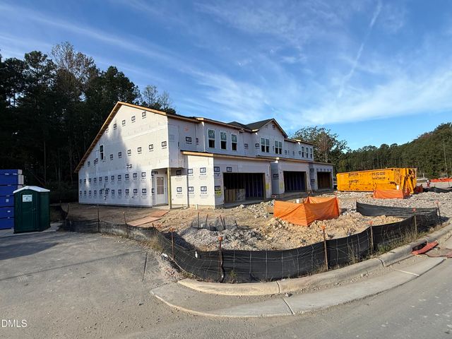 a view of a house with pool and chairs