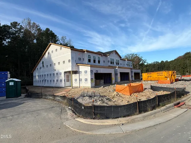 a view of a house with pool and chairs