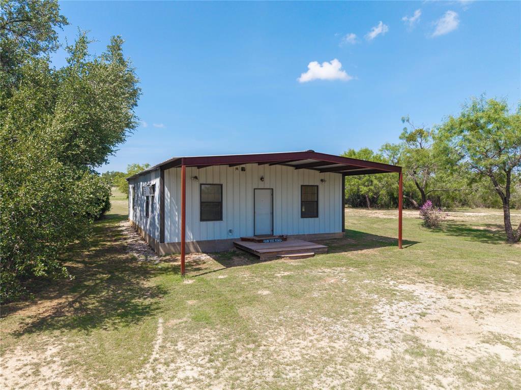 11253 County Road 525 May, TX 76857 - Photo 15 of 40 a backyard of a house with table and chairs