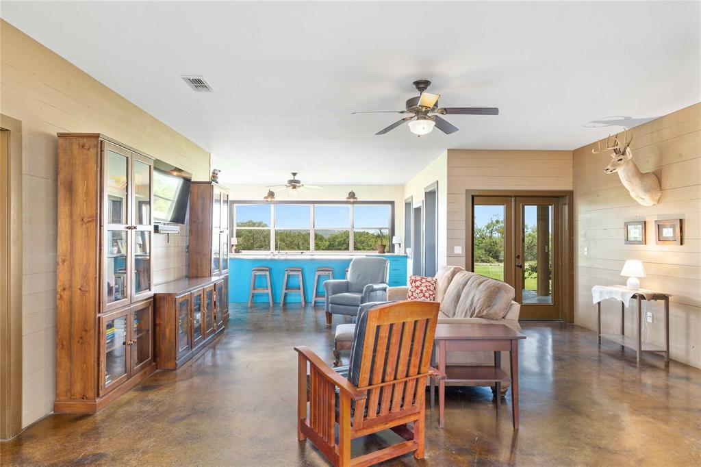 11253 County Road 525 May, TX 76857 - Photo 17 of 40 a living room with furniture a fireplace and a chandelier