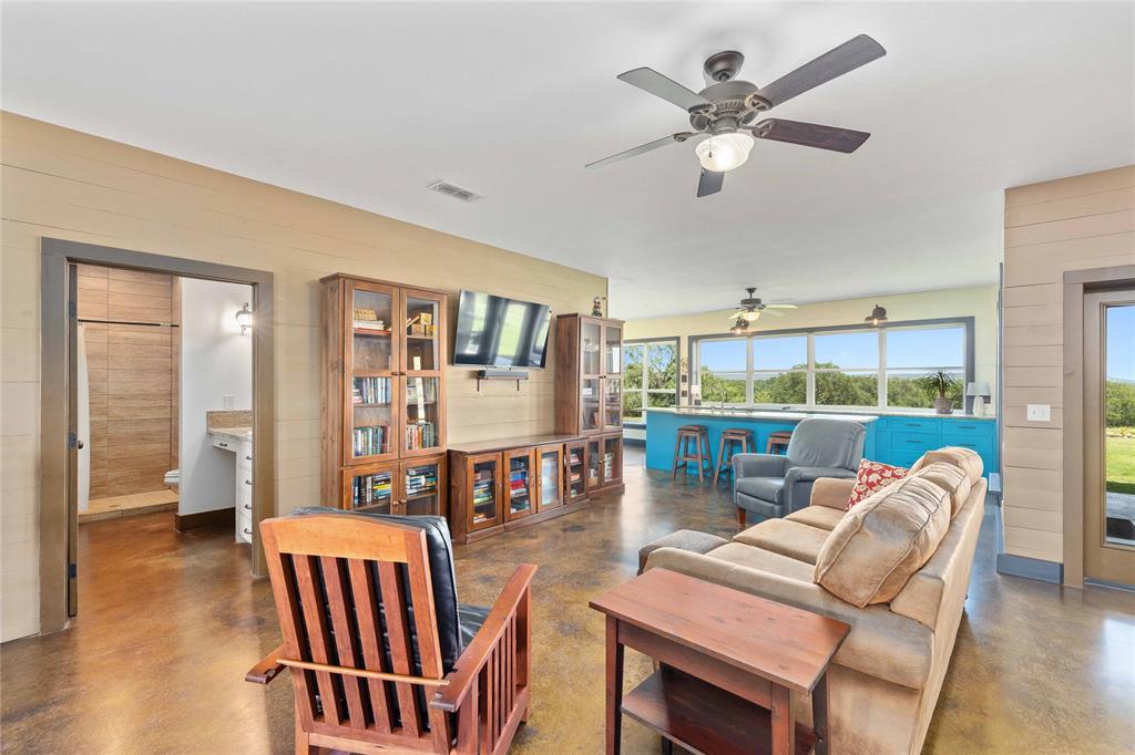 11253 County Road 525 May, TX 76857 - Photo 18 of 40 a living room with furniture a fireplace and a chandelier
