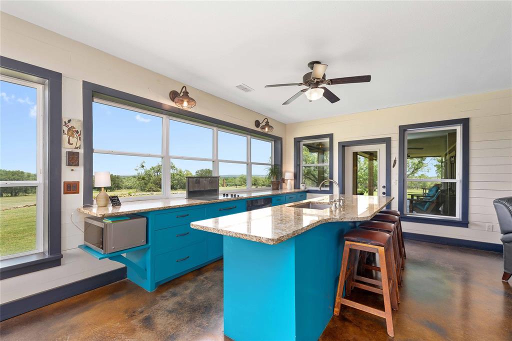 11253 County Road 525 May, TX 76857 - Photo 21 of 40 a view of a living room and kitchen with a large window