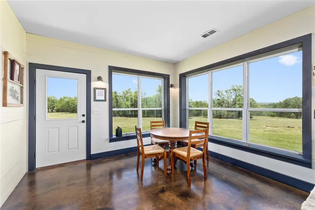 a bathroom with a granite countertop sink a mirror and shower