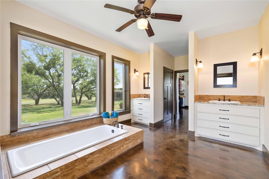 11253 County Road 525 May, TX 76857 - Photo 29 of 40 a spacious bedroom with a bed and glass window