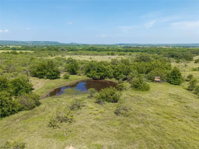 a view of a lake with houses in the back