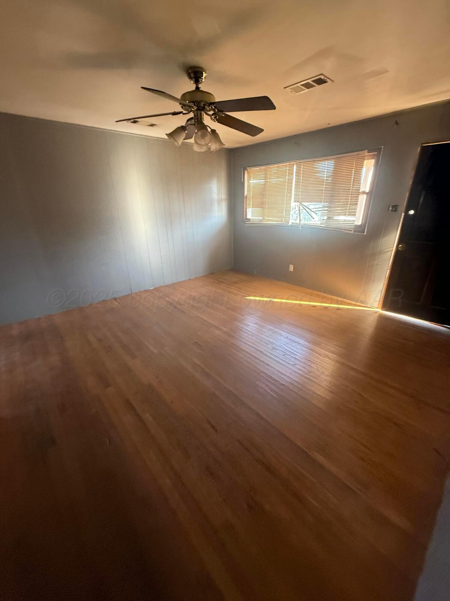 1211 North Apache Street Amarillo, TX 79107 - Photo 10 of 10 an empty room with windows and fan