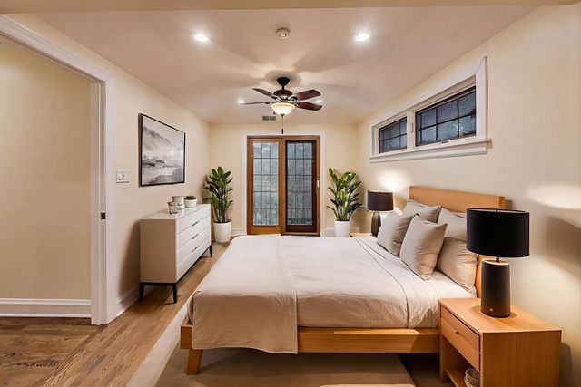 a bedroom with a bed a couch and potted plant