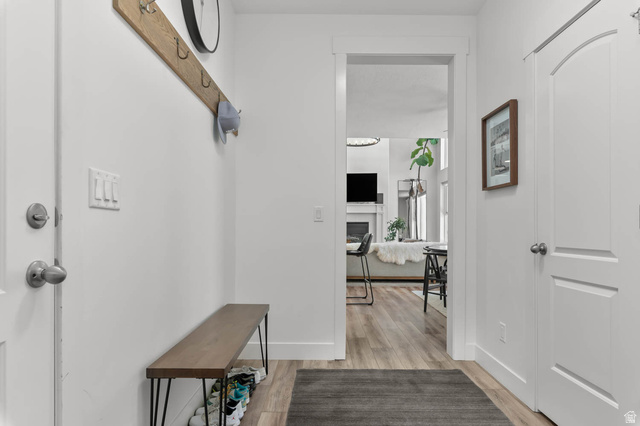 500 North 516th Street West, Unit 19 Mapleton, UT 84664 - Photo 14 of 41 Entryway with wood-finish flooring, white trim, and a functional built-in coat rack