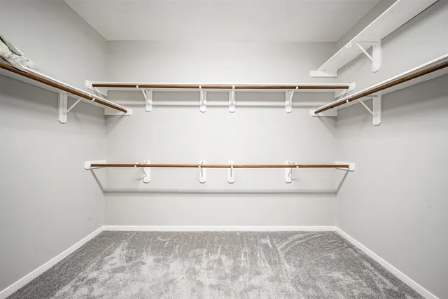 an empty room with a window and a ceiling fan