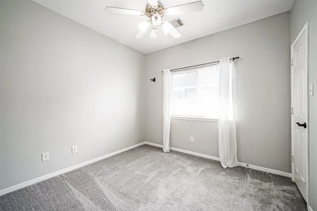 an empty room with windows and entrance