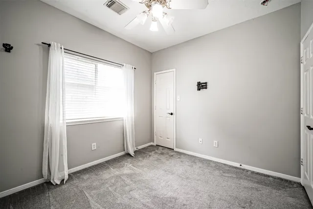 a bathroom with a granite countertop sink toilet and a mirror