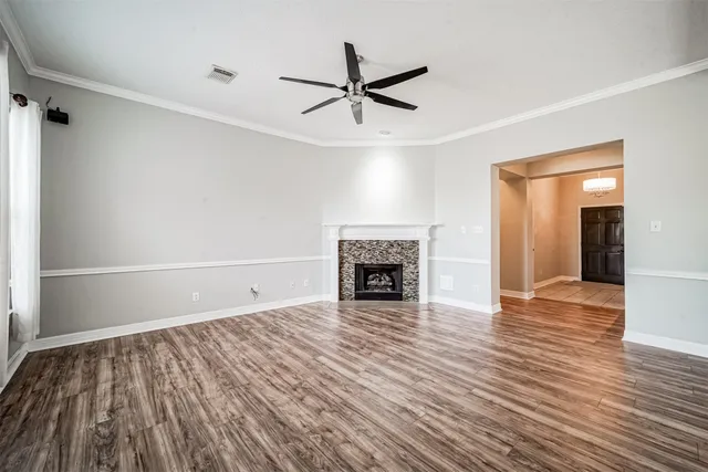 wooden floor in an empty room with a fireplace