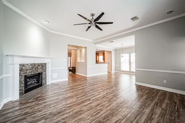 a view of empty room with wooden floor and fireplace