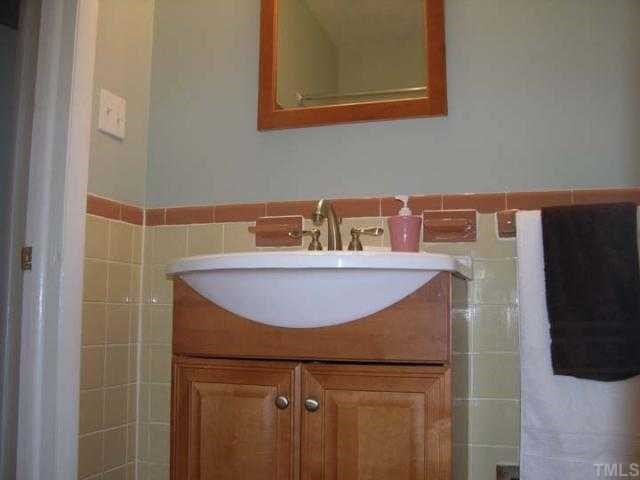 601 Poplar Drive Raleigh, NC 27603 - Photo 3 of 4 a bathroom with a sink and a mirror