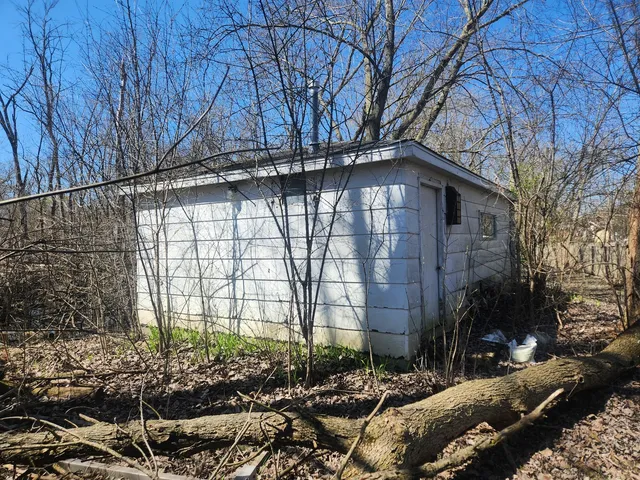 a side view of a house with a yard