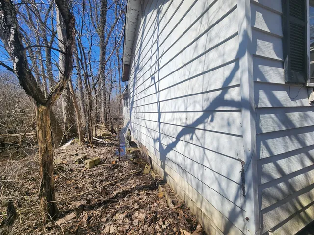 a view of a yard with wooden fence