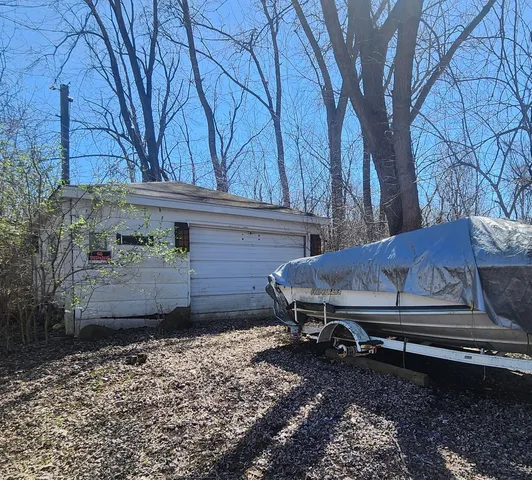 a wooden bench sitting in middle of a yard