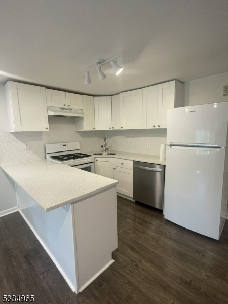 114 Osprey Road, Unit 114 Hackettstown, NJ 07840 - Photo 2 of 8 a kitchen with a refrigerator a stove top oven a sink and white cabinets