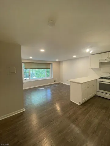 a view of a kitchen with a sink and a large window