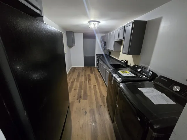a kitchen with a sink and a refrigerator