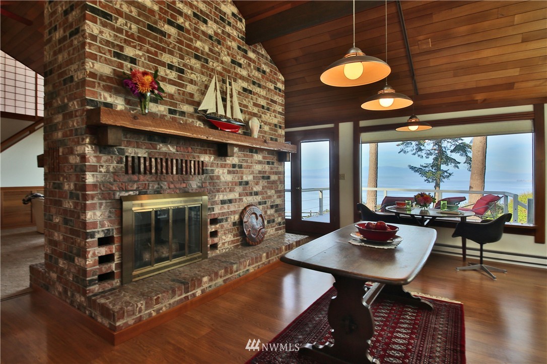 6924 Sills Road Clinton, WA 98236 - Photo 15 of 25 a living room with furniture a rug and a fireplace