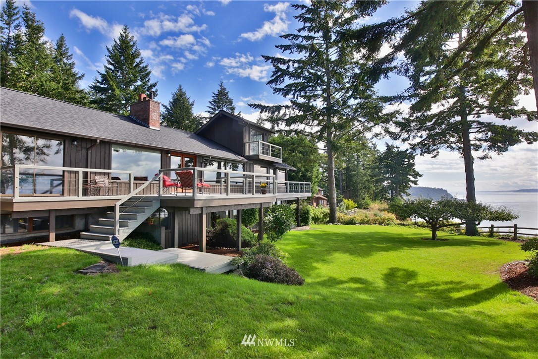 6924 Sills Road Clinton, WA 98236 - Photo 17 of 25 a view of house with a big yard and large trees