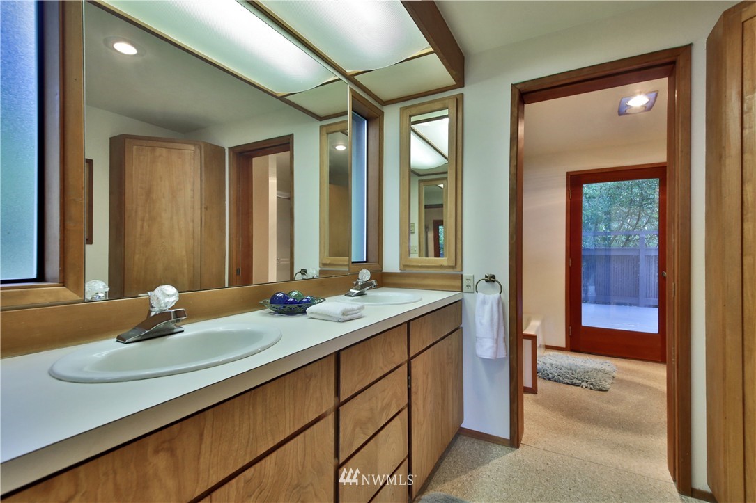 6924 Sills Road Clinton, WA 98236 - Photo 19 of 25 a bathroom with a sink and a mirror