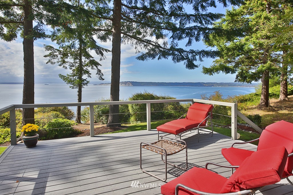 6924 Sills Road Clinton, WA 98236 - Photo 8 of 25 a chair and table sitting in wooden floor